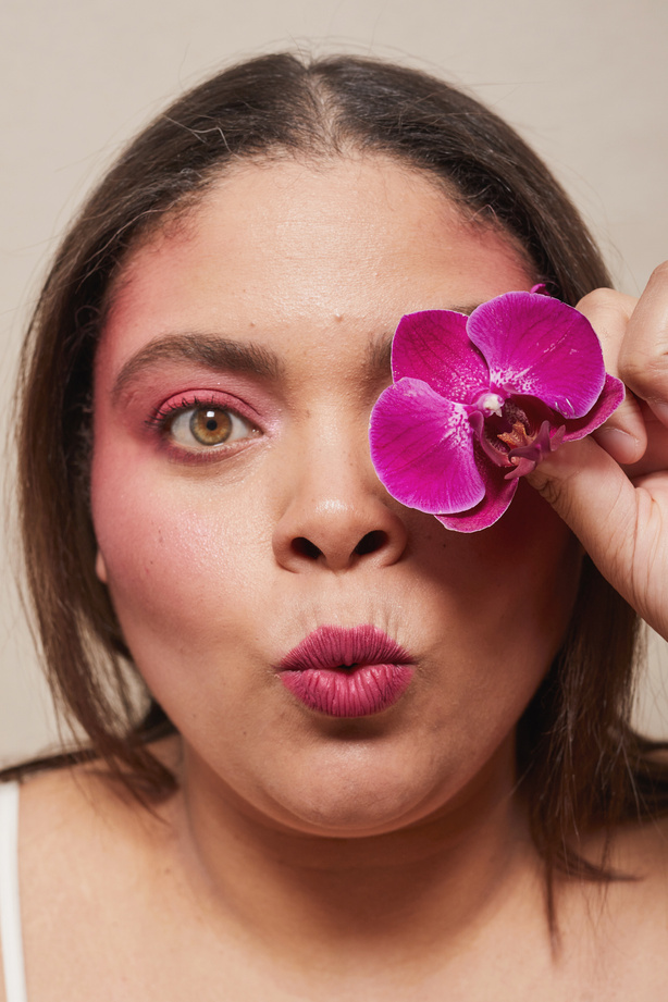 Curvy Woman with Bold Makeup and Flowers